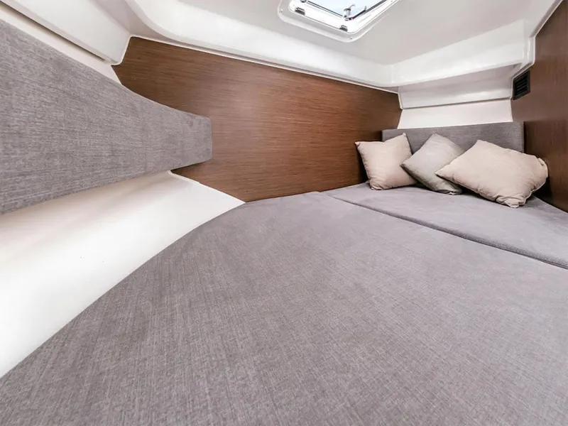 Slide: The Image of Manufacturer Provided Image: Cozy interior cabin of 2025 Beneteau Antares 8 with cushions and modern design. - 7