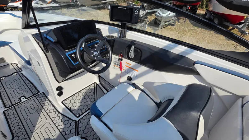 Slide: The Image of The image shows the cockpit of a 2019 Scarab 255 ID Wake Edition boat with modern instruments and a comfortable seat. - 8