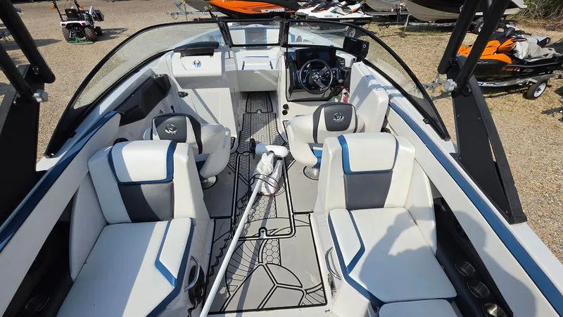 Slide: The Image of The image shows the interior of a 2019 Scarab 255 ID Wake Edition boat with modern seating and a stylish steering wheel. - 16
