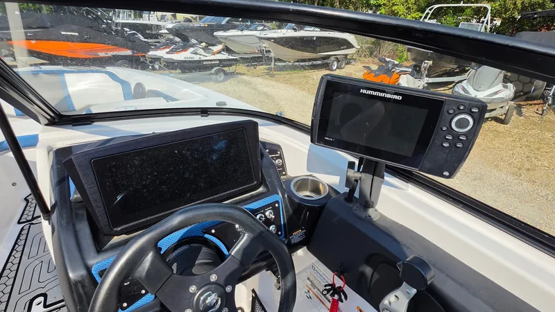Slide: The Image of The cockpit of a 2019 Scarab 255 ID Wake Edition with steering wheel and navigation system. - 9