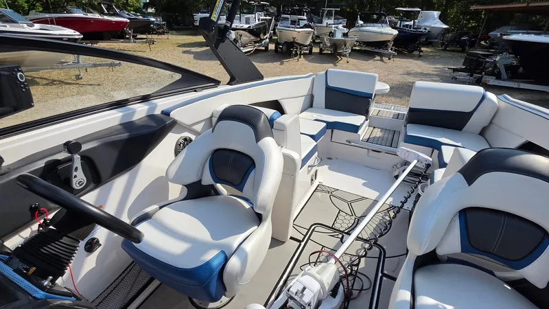 Slide: The Image of The image shows the cockpit of a 2019 Scarab 255 ID Wake Edition with modern seating and controls. - 19