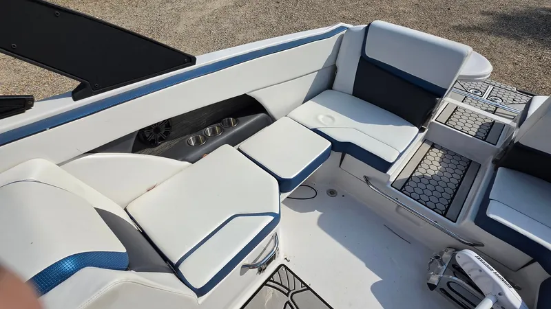 Slide: The Image of The image shows the cockpit of a 2019 Scarab 255 ID Wake Edition boat with white and blue seating. - 17