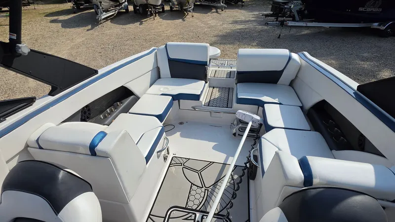 Slide: The Image of The image shows the cockpit of a 2019 Scarab 255 ID Wake Edition boat with white and blue seating. - 15