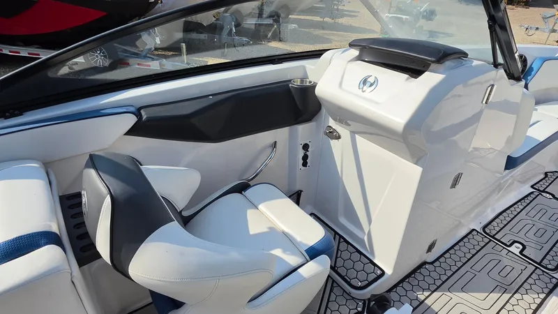 Slide: The Image of The image shows the cockpit of a 2019 Scarab 255 ID Wake Edition boat with modern seating and controls. - 7