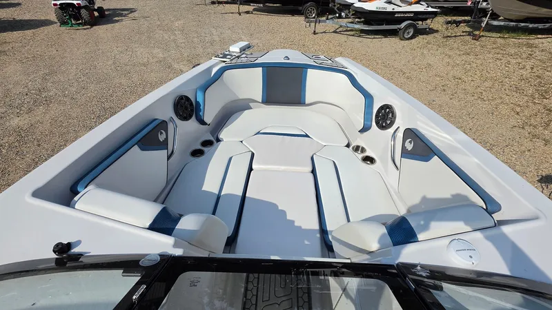 Slide: The Image of The image shows the cockpit of a 2019 Scarab 255 ID Wake Edition boat with white and blue upholstery. - 14