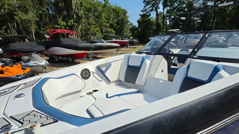 Slide: The Image of 2019 Scarab 255 ID Wake Edition with stylish white and blue interior, surrounded by other boats. - 13