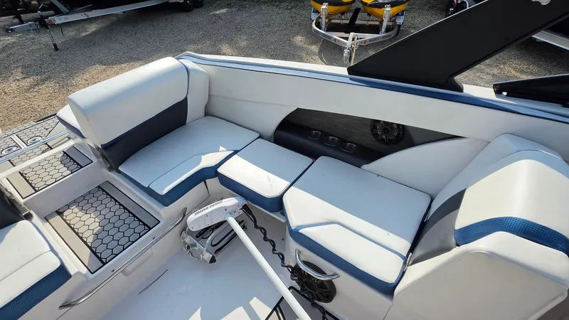 Slide: The Image of The image shows the cockpit of a 2019 Scarab 255 ID Wake Edition boat with white and blue seating. - 18