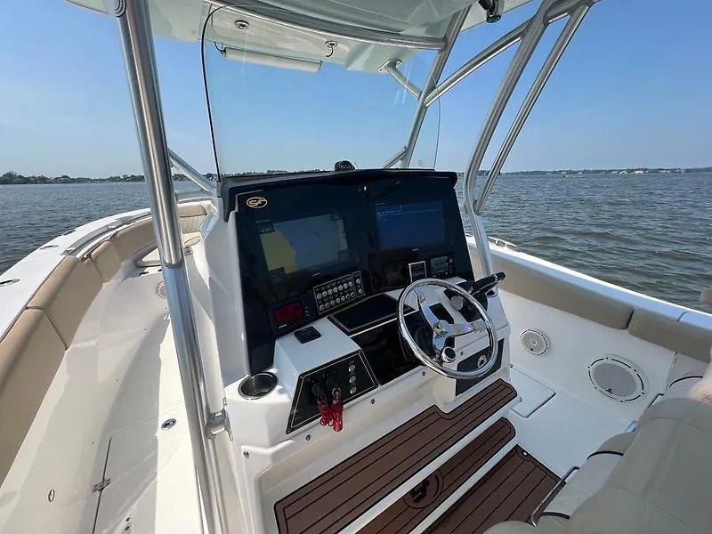 Slide: The Image of The image shows the cockpit of a 2018 Sea Fox 328 Commander with modern electronics and a stylish steering wheel. - 15