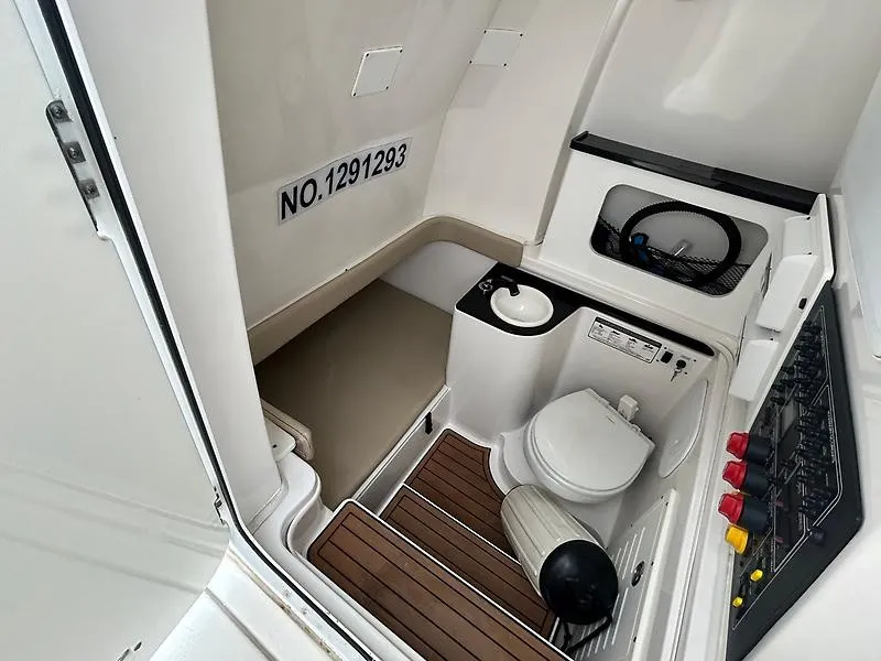 Slide: The Image of The image shows the interior of a boat with a toilet, sink, and control panel. - 22