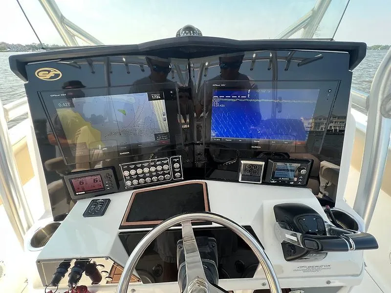 Slide: The Image of The image shows the cockpit of a 2018 Sea Fox 328 Commander with modern navigation systems. - 23