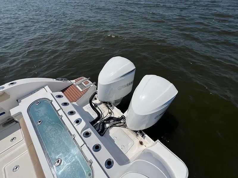 Slide: The Image of The image shows the stern of a Sea Fox 328 Commander with two Yamaha outboard engines on the water. - 12
