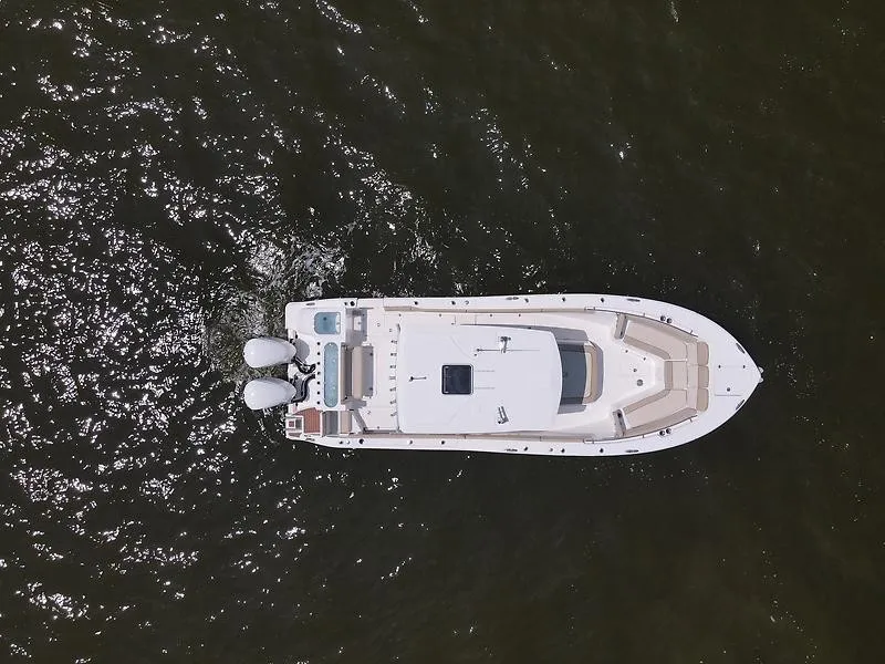 Slide: The Image of Aerial view of a white boat on the water with two outboard engines. - 4
