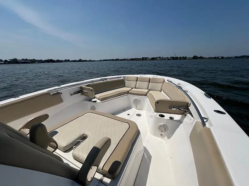 Slide: The Image of The image shows the bow of a 2018 Sea Fox 328 Commander with beige upholstery. - 13