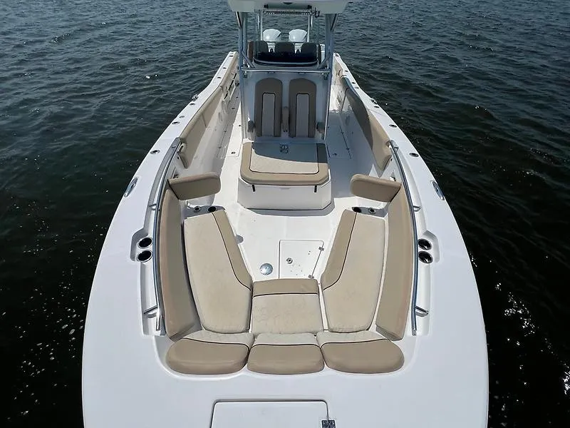 Slide: The Image of The image shows the deck of a 2018 Sea Fox 328 Commander with beige cushions. - 19