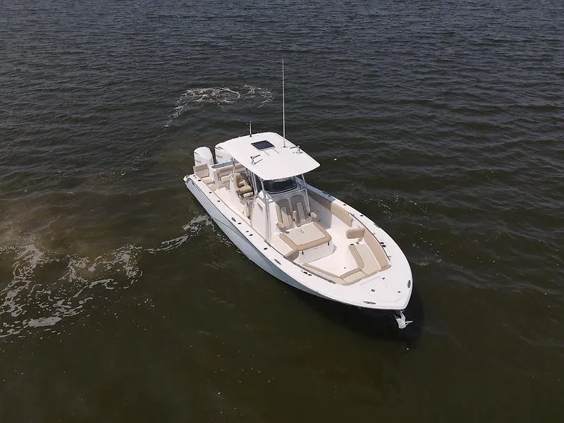 Slide: The Image of A 2018 Sea Fox 328 Commander on calm waters. The boat features a spacious deck and modern design. - 3