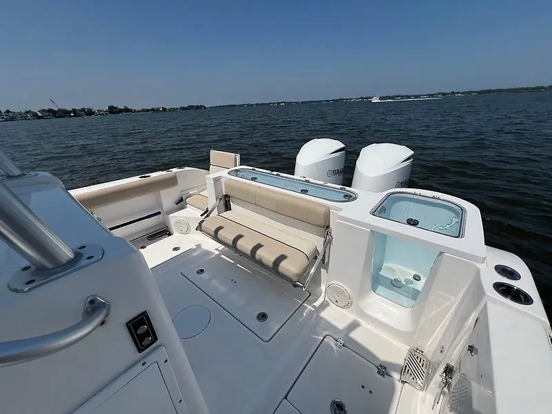 Slide: The Image of The image shows the stern of a 2018 Sea Fox 328 Commander with dual engines and a seating area. - 24