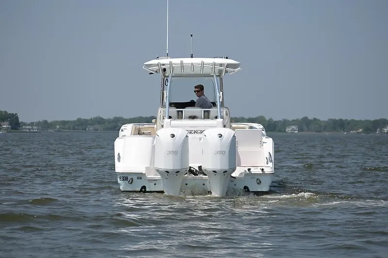 Slide: The Image of A 2018 Sea Fox 328 Commander cruising on calm water. Two engines are visible. - 26