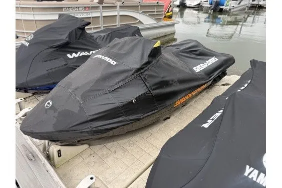 Slide: The Image of 2021 Sea-Doo GTX jet ski covered on dock, alongside other watercraft. - 10