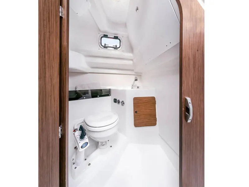 Slide: The Image of Manufacturer Provided Image: 2026 Beneteau Antares 8 Fishing boat interior bathroom with wooden accents and compact design. - 5
