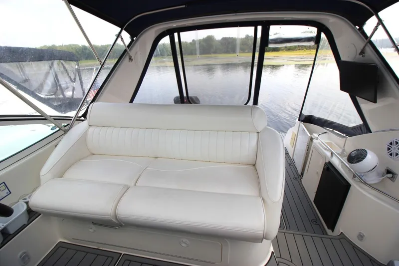 Slide: The Image of 2006 Cruisers Yachts 320 Express interior with white seating and water view. - 11