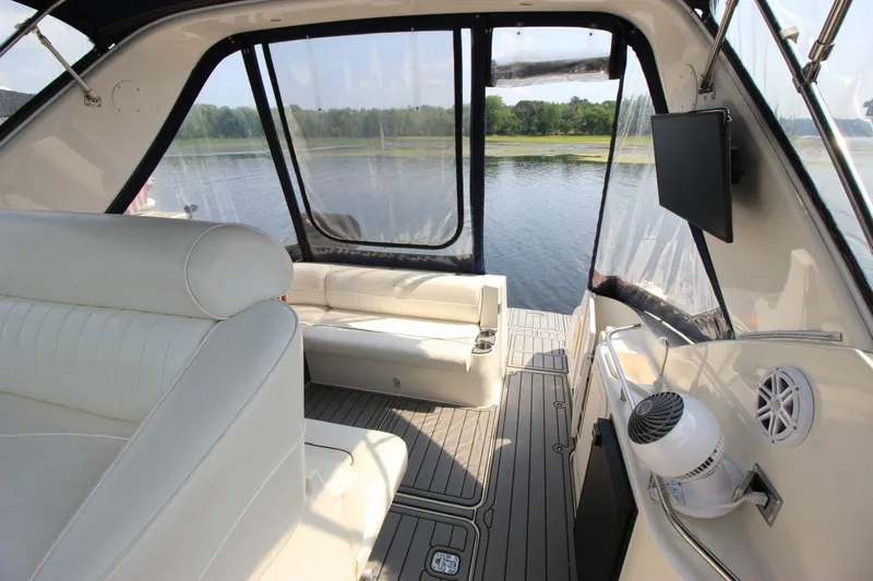 Slide: The Image of Interior of 2006 Cruisers Yachts 320 Express with white seating and lake view. - 9