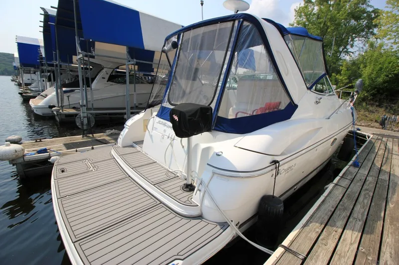 Slide: The Image of 2006 Cruisers Yachts 320 Express docked at marina, featuring sleek design and covered cockpit. - 3