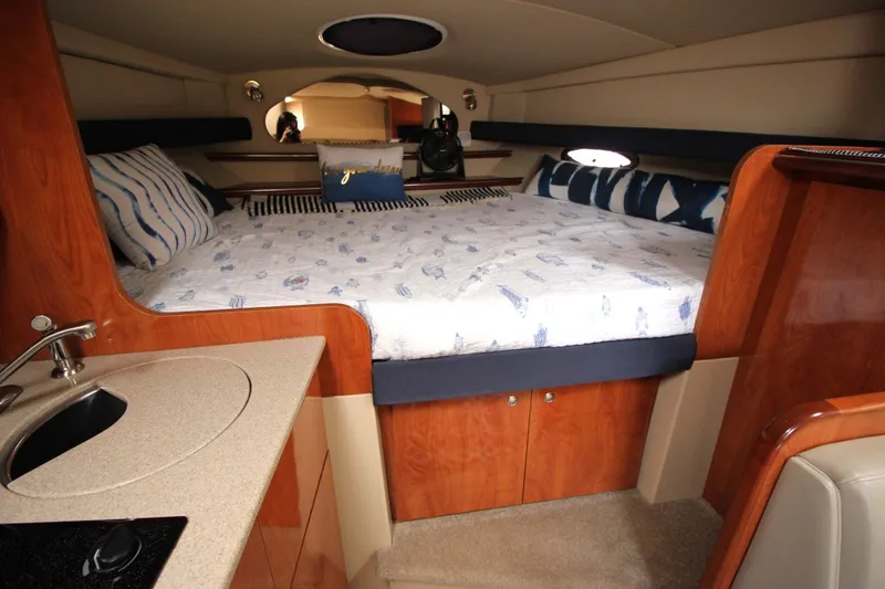 Slide: The Image of Luxurious 2006 Cruisers Yachts 320 Express cabin interior with cozy bed and compact sink. - 17