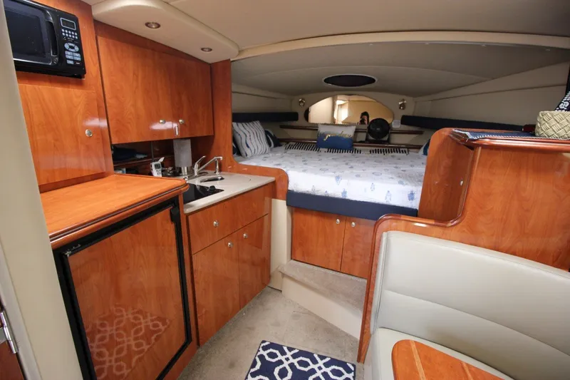 Slide: The Image of Interior of 2006 Cruisers Yachts 320 Express with kitchenette and cozy sleeping area. - 15