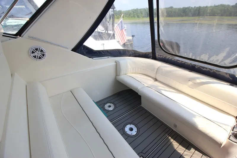 Slide: The Image of Interior of 2006 Cruisers Yachts 320 Express with white seating and lake view. - 6