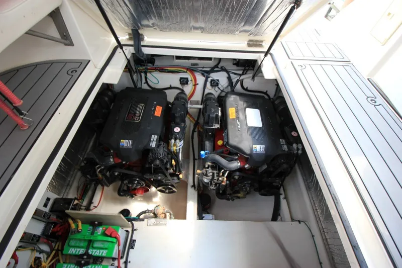 Slide: The Image of Engine compartment of 2006 Cruisers Yachts 320 Express, showcasing dual engines and battery setup. - 21