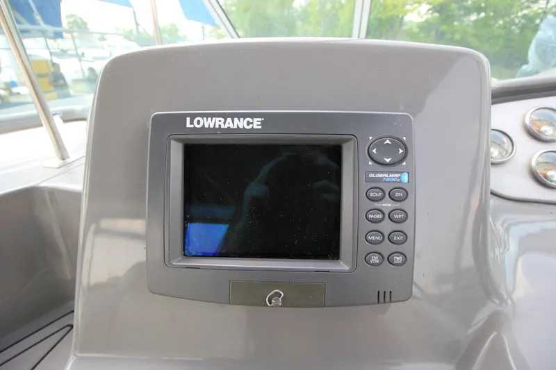 Slide: The Image of Lowrance navigation system on 2006 Cruisers Yachts 320 Express dashboard. - 13