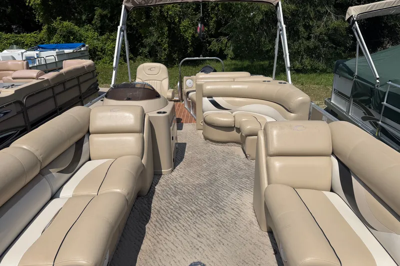 Slide: The Image of Luxurious 2012 Crest 230SLR Classic pontoon boat with beige seating and canopy. - 2