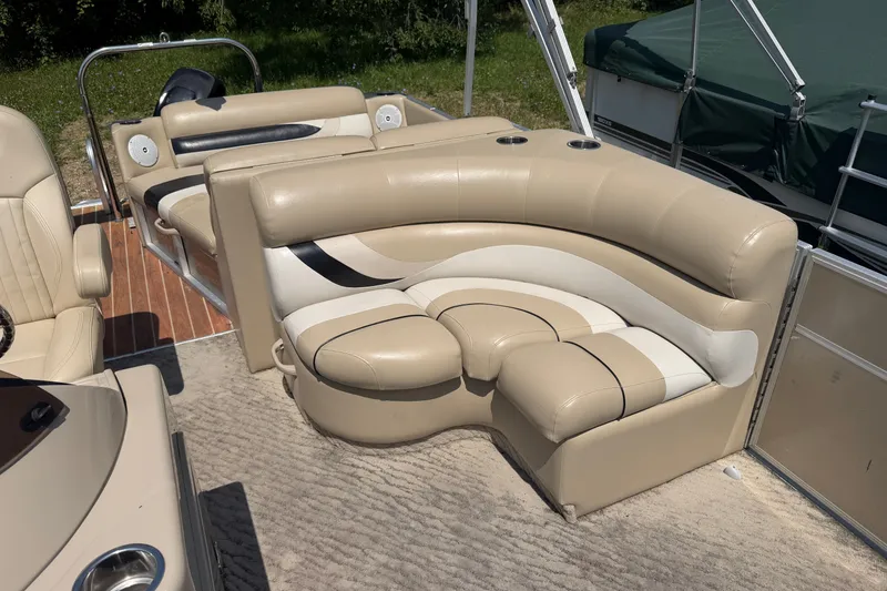 Slide: The Image of Luxurious seating on a 2012 Crest 230SLR Classic boat, featuring beige and white upholstery. - 10