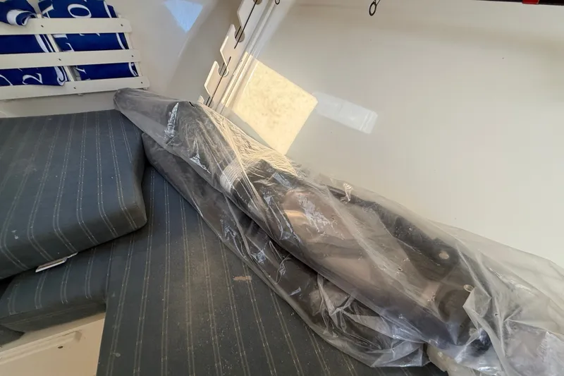 Slide: The Image of Interior of a 2005 Pursuit 265 Denali LS boat with wrapped equipment. - 12
