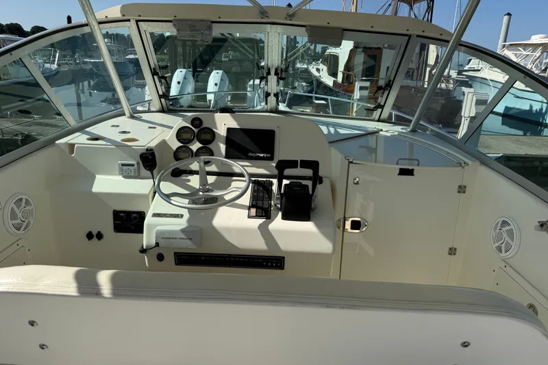Slide: The Image of 2005 Pursuit 265 Denali LS boat cockpit with steering wheel and navigation controls. - 5