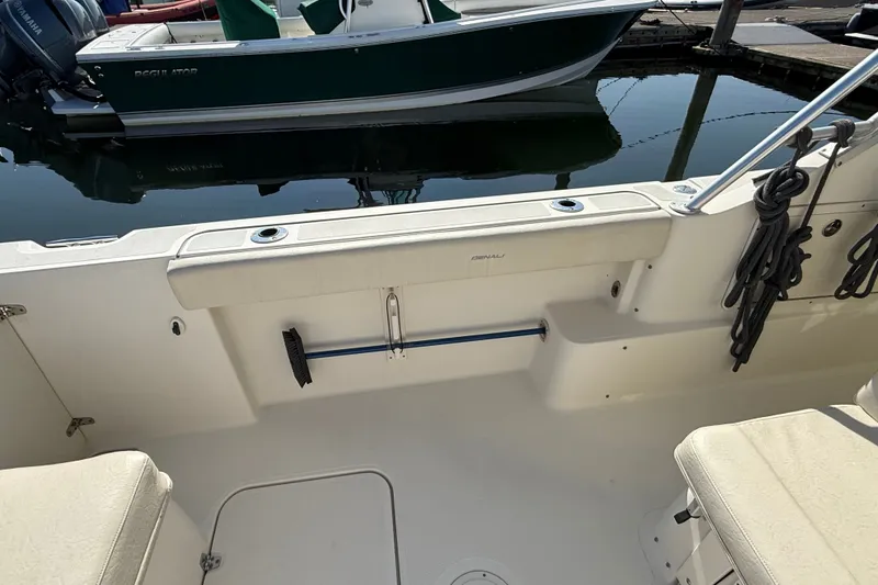Slide: The Image of 2005 Pursuit 265 Denali LS boat interior with seating and docked view. - 15