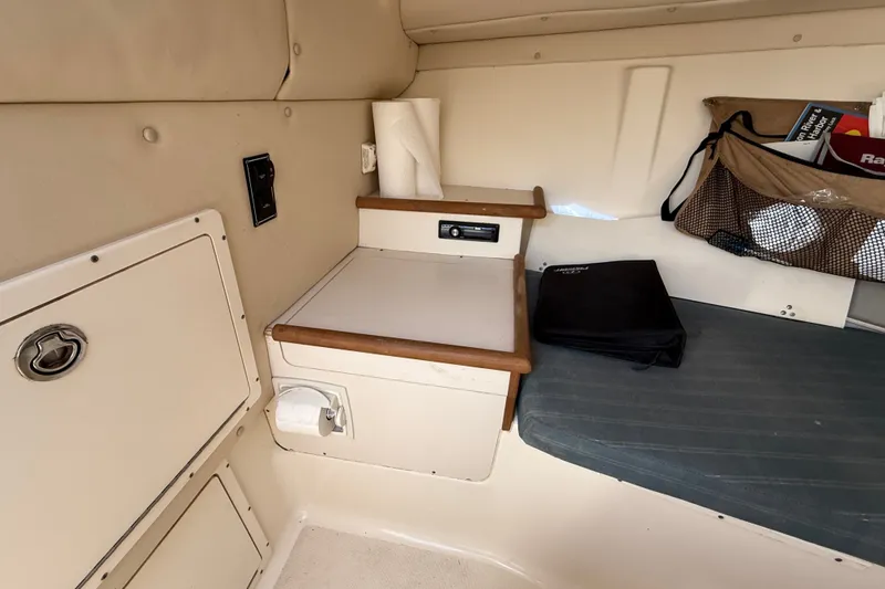 Slide: The Image of Interior cabin of a 2005 Pursuit 265 Denali LS boat with storage and seating. - 10