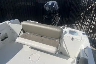 Slide: The Image of 2023 Crownline 220 CC Finseeker boat with seating and outboard motor. - 13
