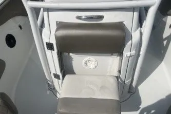 Slide: The Image of 2023 Crownline 220 CC Finseeker boat seating area with cushioned seats and storage compartment. - 11