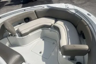 Slide: The Image of 2023 Crownline 220 CC Finseeker boat interior with cushioned seating and storage compartments. - 10