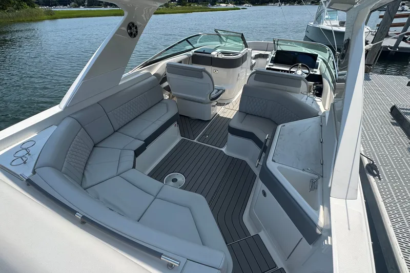 Slide: The Image of 2025 Sea Ray SLX 310 Outboard boat interior with luxurious seating and modern design. - 23
