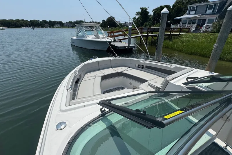 Slide: The Image of 2025 Sea Ray SLX 310 Outboard docked, showcasing spacious seating and sleek design. - 42