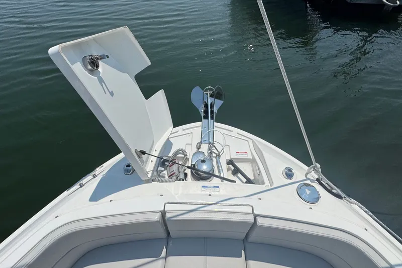 Slide: The Image of 2025 Sea Ray SLX 310 Outboard boat with open anchor compartment on calm water. - 46