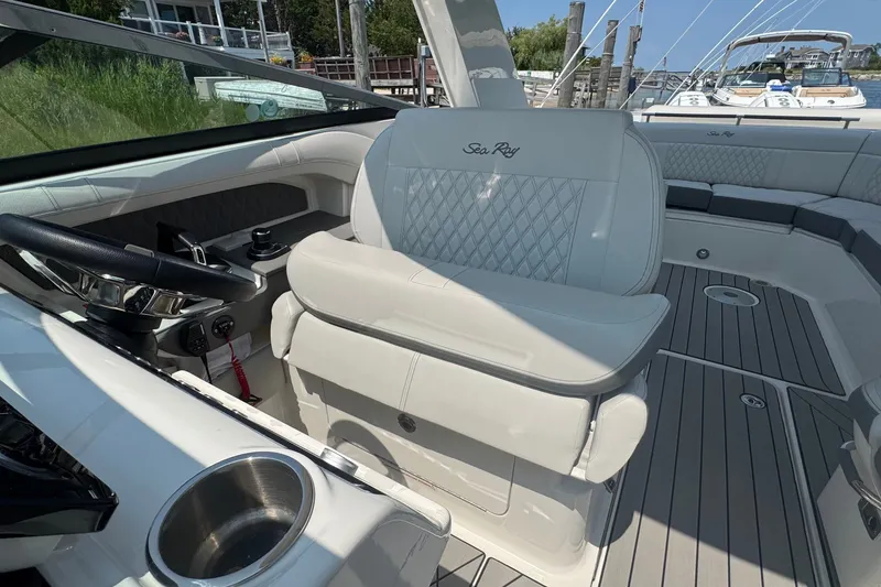 Slide: The Image of 2025 Sea Ray SLX 310 Outboard boat interior with luxurious seating and modern helm design. - 40
