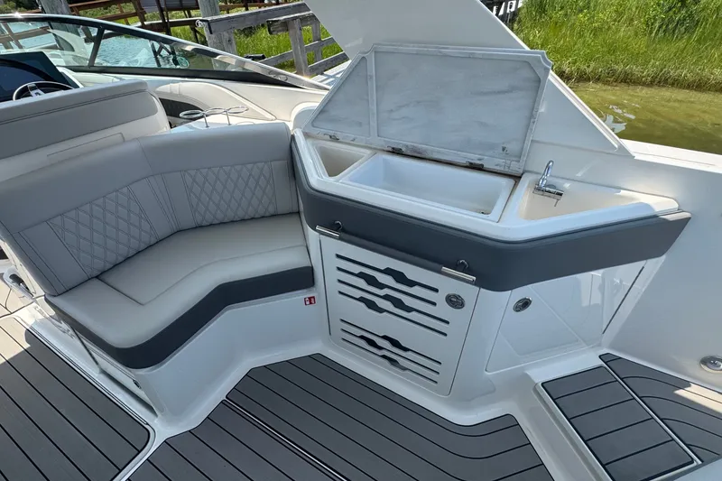 Slide: The Image of 2025 Sea Ray SLX 310 Outboard interior with seating and sink area. - 28