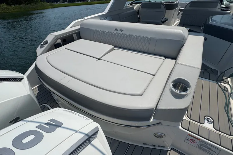 Slide: The Image of 2025 Sea Ray SLX 310 Outboard boat with luxurious seating and sleek design on the water. - 17
