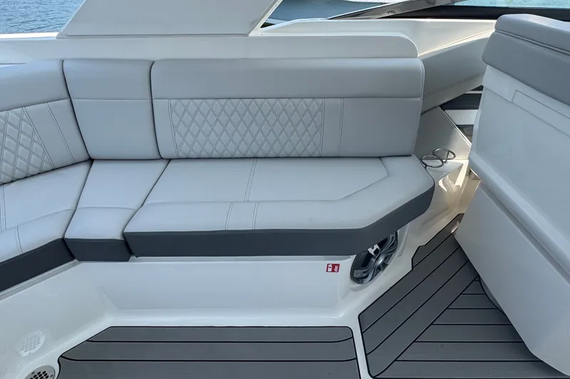 Slide: The Image of Luxurious seating on 2025 Sea Ray SLX 310 Outboard boat, featuring elegant upholstery and cup holders. - 22