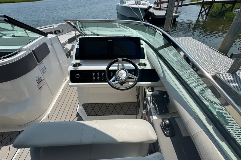 Slide: The Image of 2025 Sea Ray SLX 310 Outboard helm with modern controls and sleek design. - 35