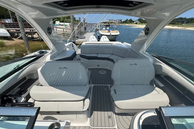Slide: The Image of 2025 Sea Ray SLX 310 Outboard luxury boat interior with plush seating and elegant design. - 38