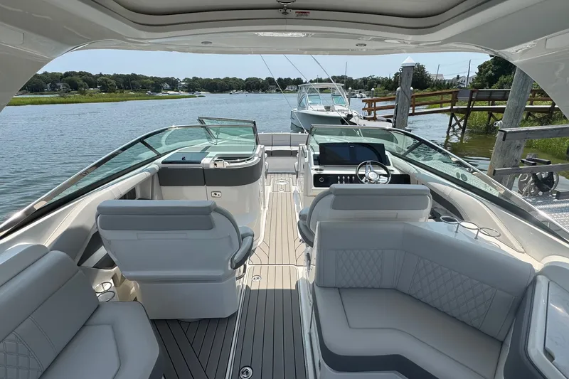 Slide: The Image of 2025 Sea Ray SLX 310 Outboard boat interior with luxurious seating and modern dashboard. - 25